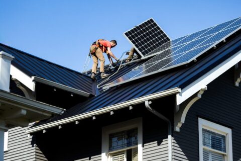 Professional crew installing solar panels on the roof in New England & Beyond