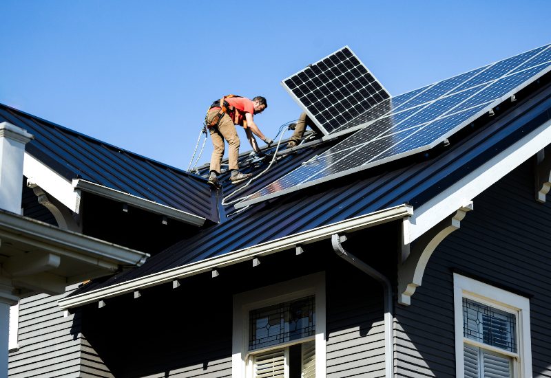 Professional crew installing solar panels on the roof in New England & Beyond