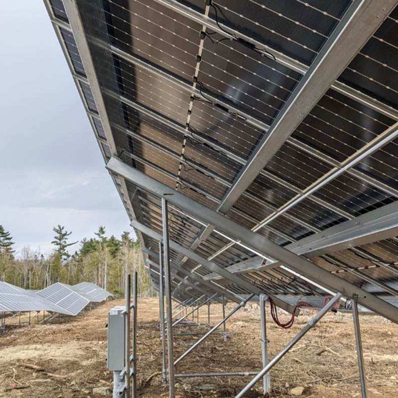 Underside View of Ground-Mounted Solar Panels at a Commercial Solar Field in Marshfield, ME
